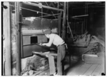 Lewis Hine child labor: Midnight scene. Cumberland Glass Works, Bridgeton, N.J. At the lehr[?]. Location: Bridgeton, New Jersey.