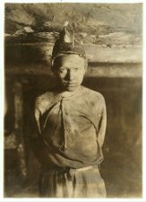 Lewis Hine: Trapper Boy, Turkey Knob Mine, Macdonald, W. Va. Boy had to stoop on account of low roof, photo taken more than a mile inside the mine. Witness E. N. Clopper. Location: MacDonald, West Virginia.