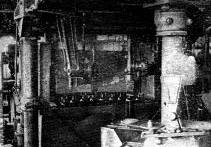 Steel fingers spacing bottles at entrance to lehr
