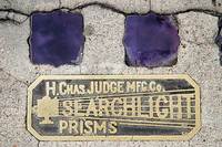 Closeup of Searchlight Prisms logo plate, San Diego, California